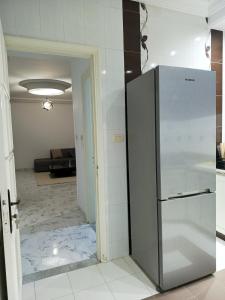 a kitchen with a stainless steel refrigerator in a room at modern apartment in Akouda