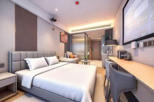 a hotel room with a bed and a television at Skyline Grand International Hotel - Prime Tianhe City Center Walkable Subway Top Pick for Canton Fair Stunning High Floor Panoramic City View Luxury Guest Rooms in Guangzhou