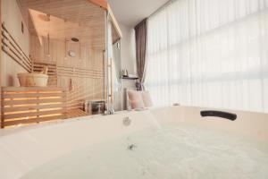 a white bath tub in a room with a window at Boutique Casa Giulietta in Como +79 photos