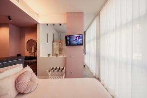 a bedroom with a bed and a tv on a wall at Boutique Casa Giulietta in Como