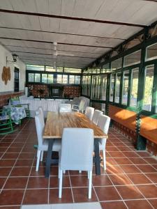 a dining room with a wooden table and white chairs at Spacious Garden Villa, private pool, huge grounds with orange trees in Dos Hermanas +67 photos