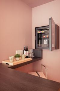 a kitchen with a counter with a refrigerator and chairs at Boutique Casa Giulietta in Como
