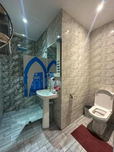 a bathroom with a sink and a toilet at Hotel Annasr in Chefchaouen +17 photos