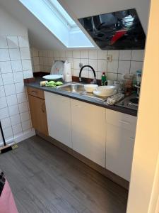 a kitchen with a sink and a counter top at Red Dot Apartment Bruno in Werne an der Lippe
