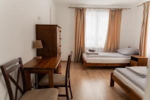 a room with a desk and a bed and a window at Mościce Dolne 69 in Nowosiółki +191 photos