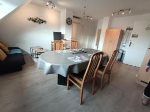 a dining room with a table and some chairs at A l'Orée du Bois ''Les Hêtres'' in Guewenheim +15 photos