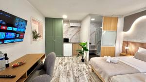 a bedroom with a bed and a desk and a kitchen at Concept Rooms in Costa de Adeje