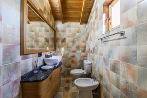 a bathroom with two toilets and a sink at Ferma Gold by PikHost in Tirana +75 photos