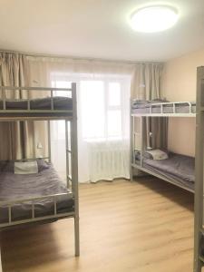 a room with three bunk beds and a window at Tara Guesthouse and Tours in Ulaanbaatar +5 photos