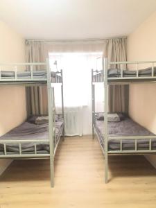 two bunk beds in a room with a window at Tara Guesthouse and Tours in Ulaanbaatar