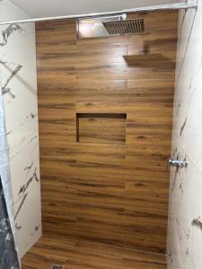 a shower with a wooden door in a bathroom at Valle Alto in Cayma