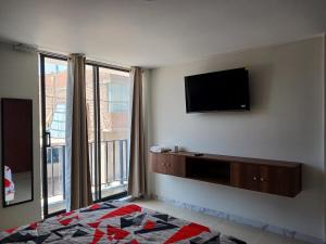 a living room with a flat screen tv on the wall at Valle Alto in Cayma