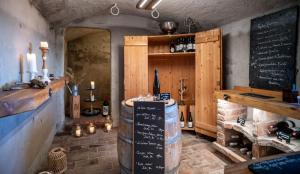 a bar with a chalkboard and wine barrels in a room at BuchackerAlm -1,5h panoramic walk in Angerberg