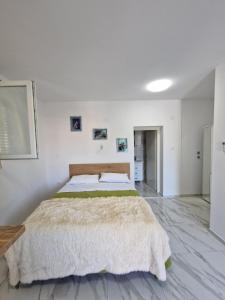 a bedroom with a large bed in a white wall at Sunce 5 in Vrbnik