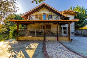 a house with a porch and a balcony at Ferma Gold by PikHost in Tirana