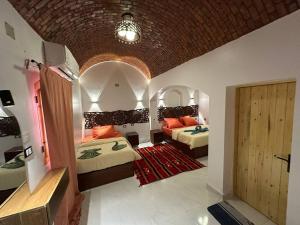a bedroom with two beds and an arched ceiling at Queen House in Aswan