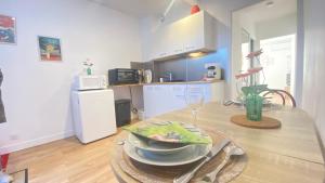 a kitchen with a table with a bowl of food on it at Le Cocon du Hameau in Bidart
