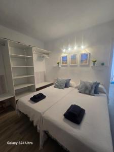 a bedroom with two beds with towels on them at APT Copacabana-Es Pujols playa in Es Pujols