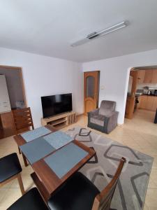 a living room with a dining table and a television at House in Zabierzów in Zabierzów