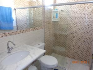 ein Bad mit einem WC, einem Waschbecken und einer Dusche in der Unterkunft Jardim Atlantico in Paripueira