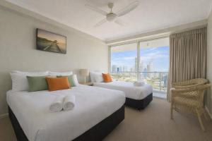 a hotel room with two beds and a large window at L17 Small Studio Suite 2 Beds Pool Spa in Gold Coast
