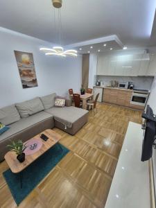a living room with a couch and a table at Apartman Mina in Požarevac