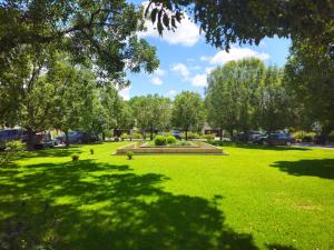 a park with trees and a fountain in the grass at Terrazas de San Lorenzo - Salta in San Lorenzo +28 photos