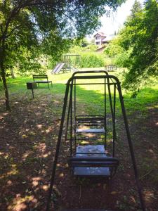 a swing set in a park with a park bench at Terrazas de San Lorenzo - Salta in San Lorenzo