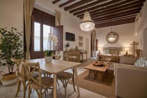 a living room with a table and a couch at Can Savella - Turismo de Interior in Palma de Mallorca