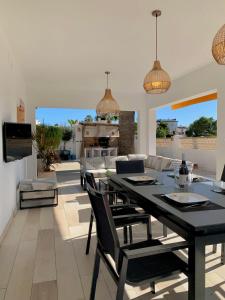 a dining room with a black table and chairs at Casa Laura by Sun & Sea Homes in Moraira