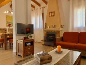 a living room with a couch and a fireplace at Casa Laura by Sun & Sea Homes in Moraira