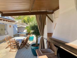 a patio with a table and chairs and a fireplace at Casa Laura by Sun & Sea Homes in Moraira