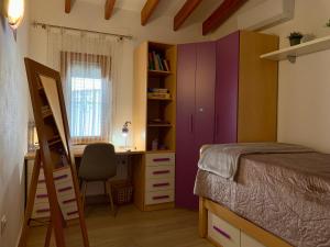 a bedroom with a bed and a desk and a chair at Casa Laura by Sun & Sea Homes in Moraira +14 photos