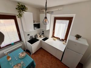 a small kitchen with a sink and a table at Casa Nausicaa in Pergine Valsugana