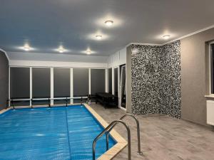 a swimming pool in a room with a wall at Villa 121 Várgesztes in Várgesztes