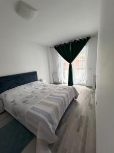 a bedroom with a bed and a window at Favorite Apartmet in Braşov