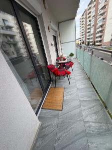 a balcony with a table and chairs on a building at Favorite Apartmet in Braşov