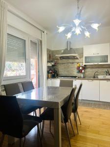 a kitchen with a dining room table and chairs at Suite AeF Lido di Ostia in Lido di Ostia