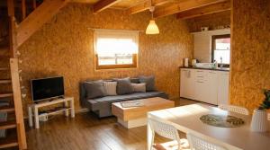 a living room with a couch and a table at Cichosza Miłomłyn in Miłomłyn