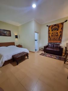 a large bedroom with a bed and a fireplace at Comfy Room Yogyakarta BY Hamsa Putih in Yogyakarta