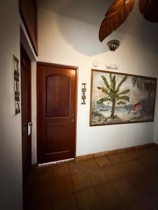 a hallway with a door and a painting on the wall at Acacia Boutique Hotel in San Juan +70 photos