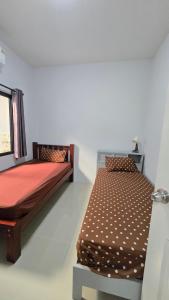 a bedroom with two beds and a window at Joyful House Naiyang beach in Thalang +25 photos