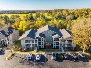an aerial view of a home with cars parked in a parking lot at Branson 2BR Retreat | Jacuzzi + Gym + Pools in Hollister