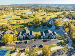 an aerial view of a community of homes with a lake at Branson 2BR Retreat | Jacuzzi + Gym + Pools in Hollister