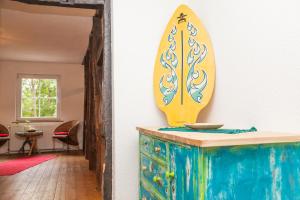 a surfboard on top of a dresser in a room at Canoe Welcome in Hattingen