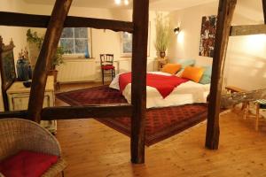 a bedroom with a wooden bed with a red blanket at Canoe Welcome in Hattingen +8 photos
