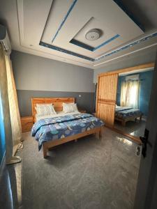 a bedroom with a bed and a coffered ceiling at Résidence NDAR in Saint-Louis