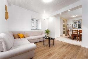 a white living room with a couch and a table at Apartment Alen in Makarska