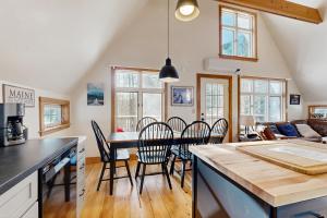 a kitchen and dining room with a table and chairs at Mullen Chalet in Greenwood