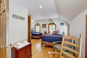 a bedroom with a bed and a chair in a room at Mullen Chalet in Greenwood